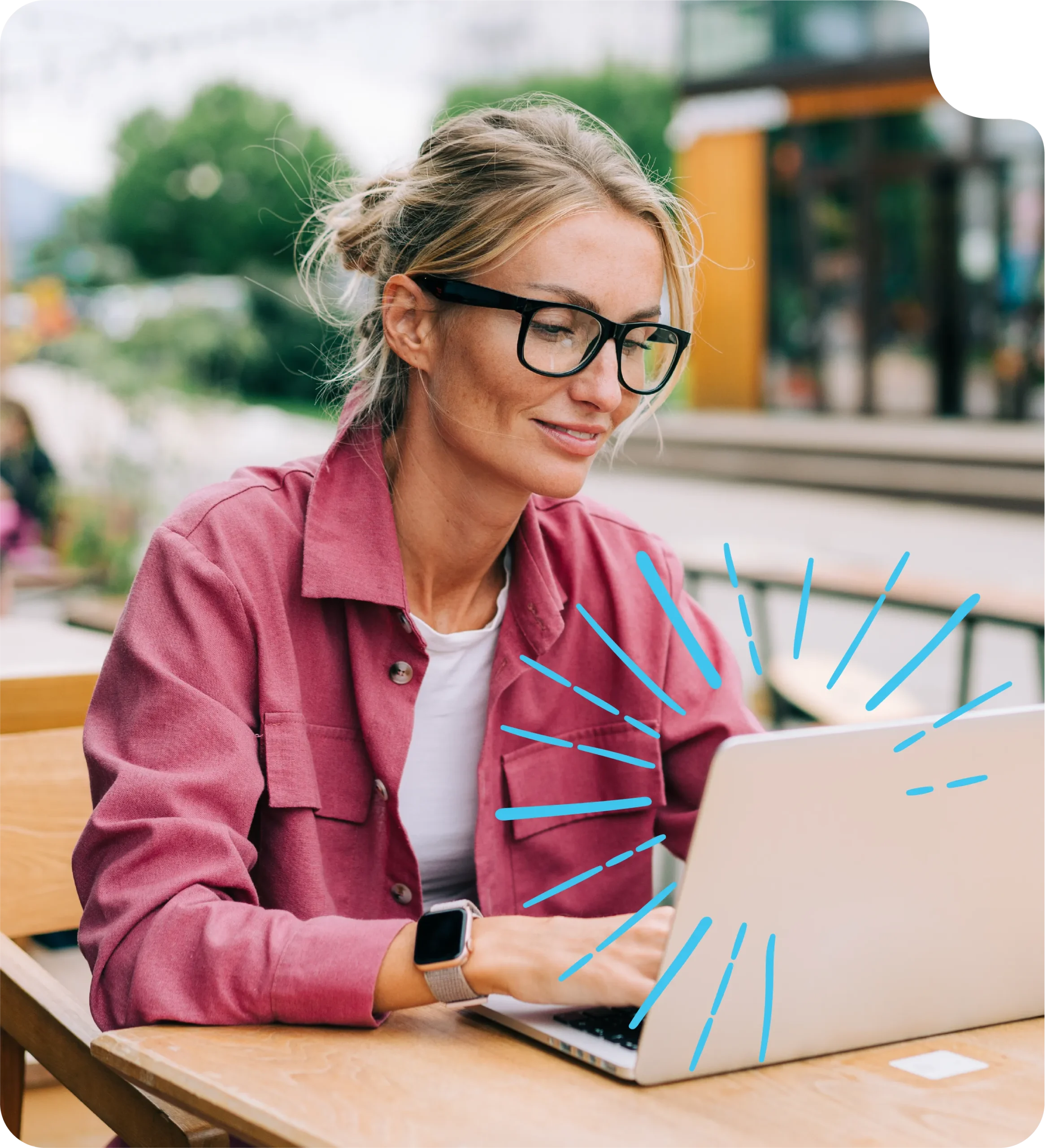 Woman sat at table in a cafe using her laptop